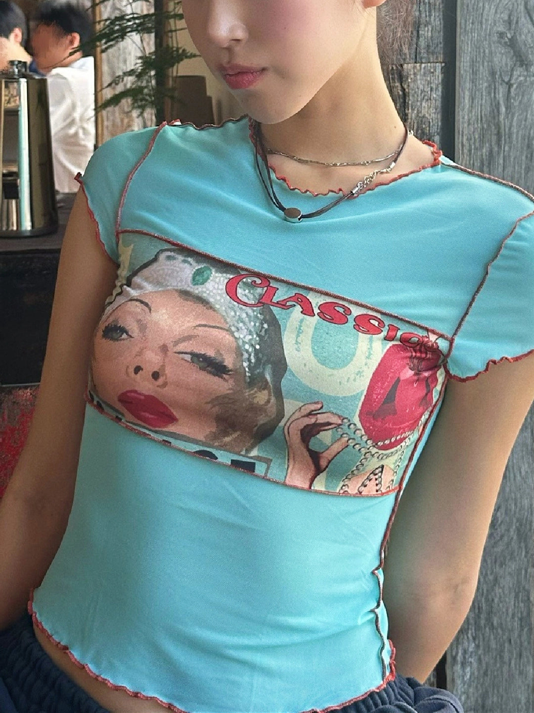 Shemoda: Roxy Vintage Tee | Nüra - Discover the Roxy Vintage Tee by Shemoda: a retro-inspired top with a ghost horse girl print and mesh panels for a bold, artistic look. - $19.00
