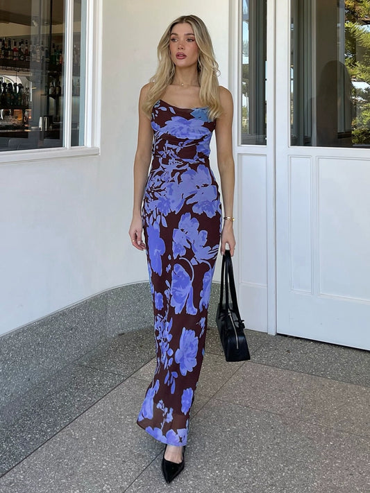 Shemoda: Ocean Bloom Dress | Nüra - Discover Shemoda's Ocean Bloom Dress: a bold blue floral maxi with crisscross straps and backless design. Perfect for vacations and warm events. - $24.00