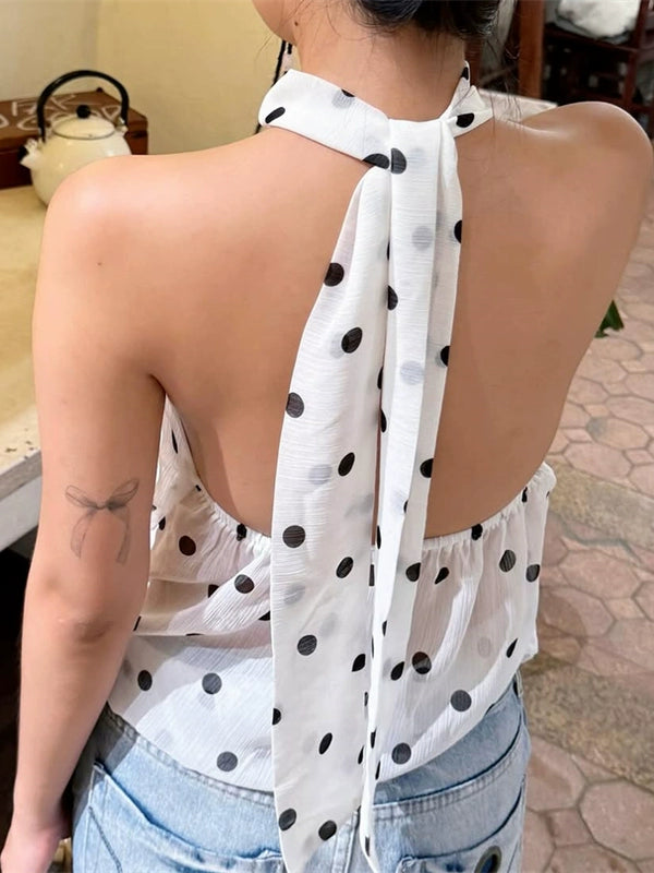 Shemoda: Zuri Halter Blouse | Nüra - Discover the Zuri Halter Blouse by Shemoda: a chic, backless chiffon top with playful polka dots and adjustable neck straps for versatile style. - $25.00