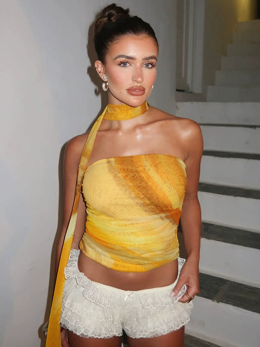 Shemoda: Amber Drift Top | Nüra - Elevate your summer style with Shemoda's Amber Drift Top. This strapless, ruched crop top features a yellow-orange gradient and a chic neck scarf. - $19.00