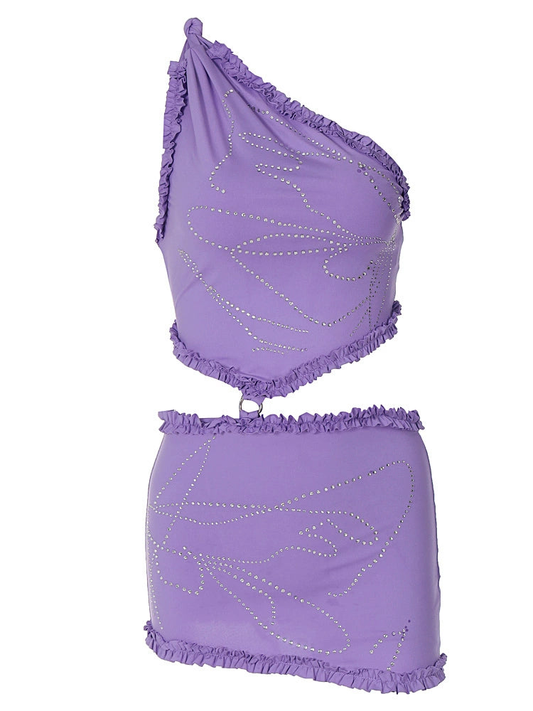 Shemoda: Cira Skirt Set | Nüra - Shine in Shemoda's Cira Skirt Set: a ruffled one-shoulder crop top and sparkle mini skirt. Perfect for bold nights and chic photo moments. - $24.00