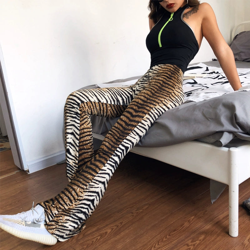 Shemoda: Iris Ember Pants | Nüra - Elevate your style in 2025 with Shemoda's Iris Ember Pants. High-waist, slimming flares in bold leopard & tiger prints for a retro, flattering fit. - $19.00