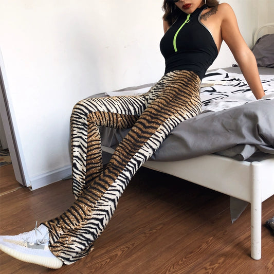 Shemoda: Iris Ember Pants | Nüra - Elevate your style in 2025 with Shemoda's Iris Ember Pants. High-waist, slimming flares in bold leopard & tiger prints for a retro, flattering fit. - $19.00