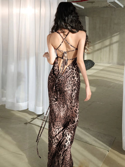 Shemoda: Willow Wildprint Dress | Nüra - Discover Shemoda's Willow Wildprint Dress: a bold leopard print with a backless cut, draped neckline, and flowing mesh skirt for effortless elegance. - $21.00