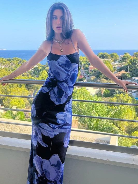 Shemoda: Meadow Dew Maxi Dress | Nüra - Discover the Meadow Dew Maxi Dress by Shemoda: a sleek, sexy vacation style with blue floral print, crisscross back, and fitted silhouette. - $21.00