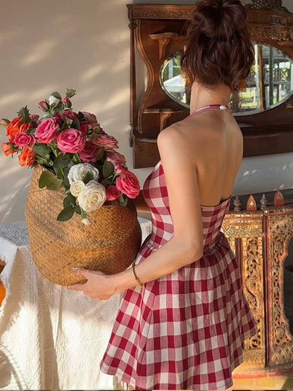 Shemoda: Freya Retro Halter Dress | Nüra - Discover Shemoda's Freya Retro Halter Dress: a chic Hong Kong-style plaid dress with a backless cut and pleated skirt, perfect for summer outings. - $19.00