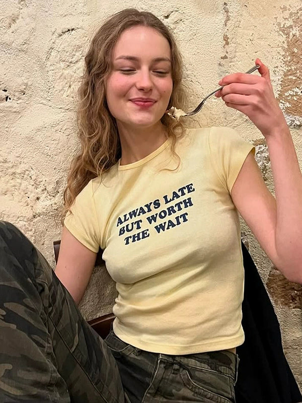 Shemoda: Lira Printed Tee | Nüra - Discover Shemoda's Lira Printed Tee: a chic, fitted crop with cheeky text. Perfectly pairs with high-waisted styles for a confident look. - $17.00