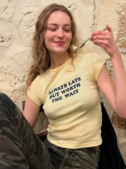 Shemoda: Lira Printed Tee | Nüra - Discover Shemoda's Lira Printed Tee: a chic, fitted crop with cheeky text. Perfectly pairs with high-waisted styles for a confident look. - $17.00
