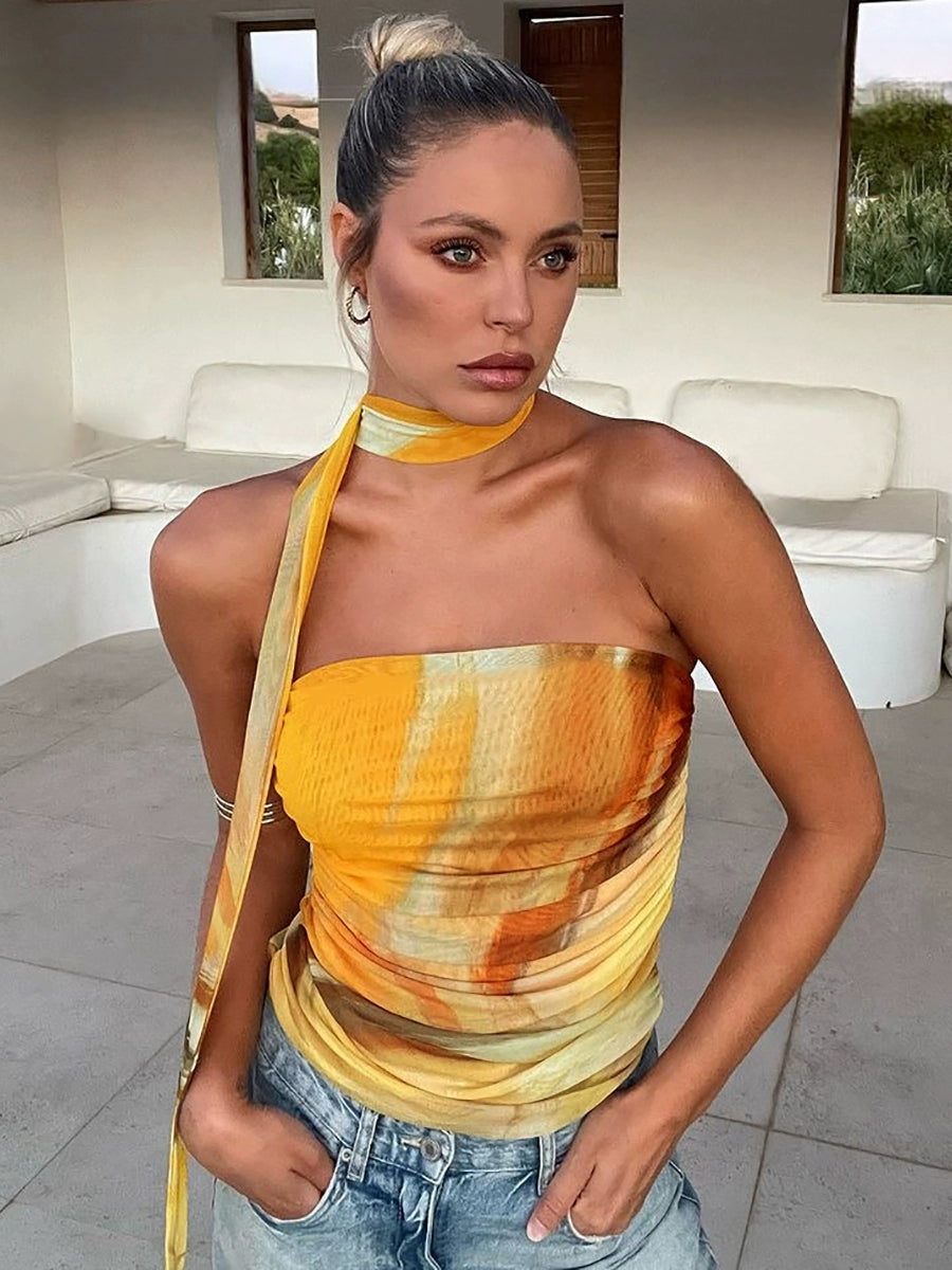 Shemoda: Amber Drift Top | Nüra - Elevate your summer style with Shemoda's Amber Drift Top. This strapless, ruched crop top features a yellow-orange gradient and a chic neck scarf. - $19.00