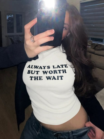 Shemoda: Lira Printed Tee | Nüra - Discover Shemoda's Lira Printed Tee: a chic, fitted crop with cheeky text. Perfectly pairs with high-waisted styles for a confident look. - $17.00