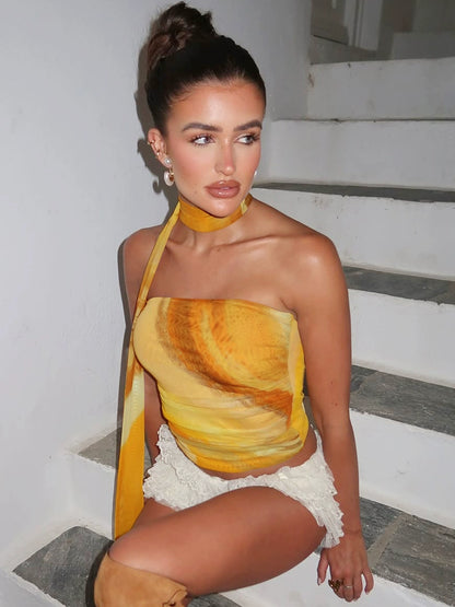 Shemoda: Amber Drift Top | Nüra - Elevate your summer style with Shemoda's Amber Drift Top. This strapless, ruched crop top features a yellow-orange gradient and a chic neck scarf. - $19.00