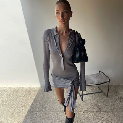 Shemoda: Lexi Shirt Dress | Nüra - Discover elegance with Shemoda's Lexi Shirt Dress. Featuring a slimming fit, classic collar, and asymmetrical ruched hem for a chic look. - $30.00