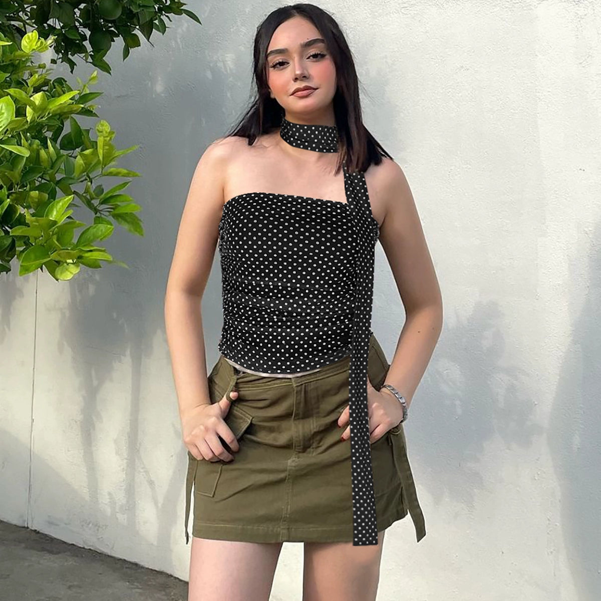 Shemoda: Kara Wrap Top | Nüra - Discover Shemoda's chic Kara Wrap Top: a polka dot crop with an asymmetric neckline, ruched sides, and a unique scarf-like neck strap. - $17.00