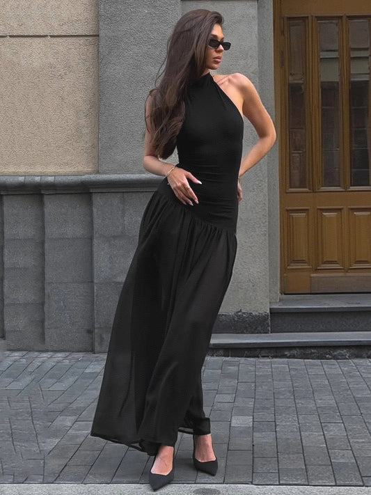 Shemoda: Delia Evening Maxi Dress | Nüra - Elevate your style with Shemoda's Delia Evening Maxi Dress. A black, backless halter dress with a ruffled neckline and elegant mesh skirt. - $27.00