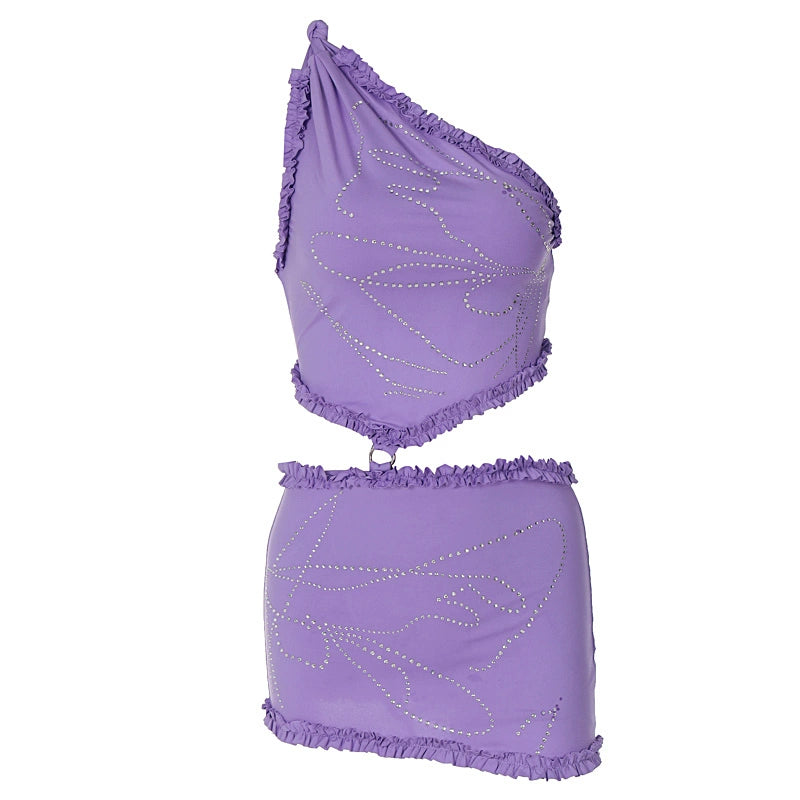 Shemoda: Cira Skirt Set | Nüra - Shine in Shemoda's Cira Skirt Set: a ruffled one-shoulder crop top and sparkle mini skirt. Perfect for bold nights and chic photo moments. - $24.00