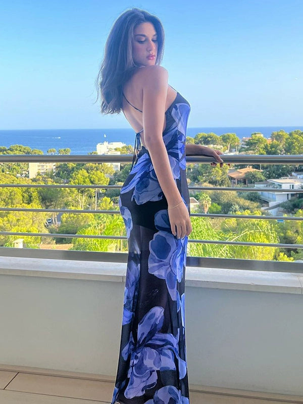 Shemoda: Meadow Dew Maxi Dress | Nüra - Discover the Meadow Dew Maxi Dress by Shemoda: a sleek, sexy vacation style with blue floral print, crisscross back, and fitted silhouette. - $21.00