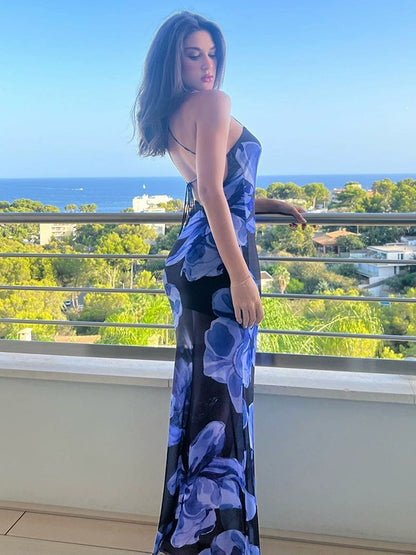 Shemoda: Meadow Dew Maxi Dress | Nüra - Discover the Meadow Dew Maxi Dress by Shemoda: a sleek, sexy vacation style with blue floral print, crisscross back, and fitted silhouette. - $21.00