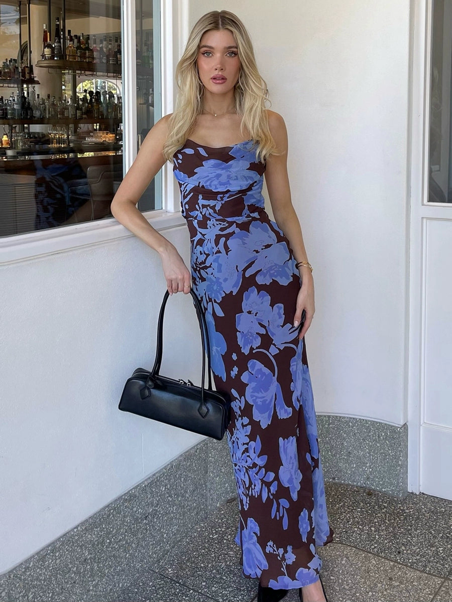 Shemoda: Ocean Bloom Dress | Nüra - Discover Shemoda's Ocean Bloom Dress: a bold blue floral maxi with crisscross straps and backless design. Perfect for vacations and warm events. - $24.00