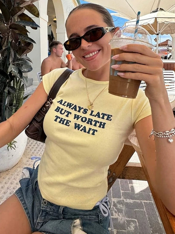 Shemoda: Lira Printed Tee | Nüra - Discover Shemoda's Lira Printed Tee: a chic, fitted crop with cheeky text. Perfectly pairs with high-waisted styles for a confident look. - $17.00