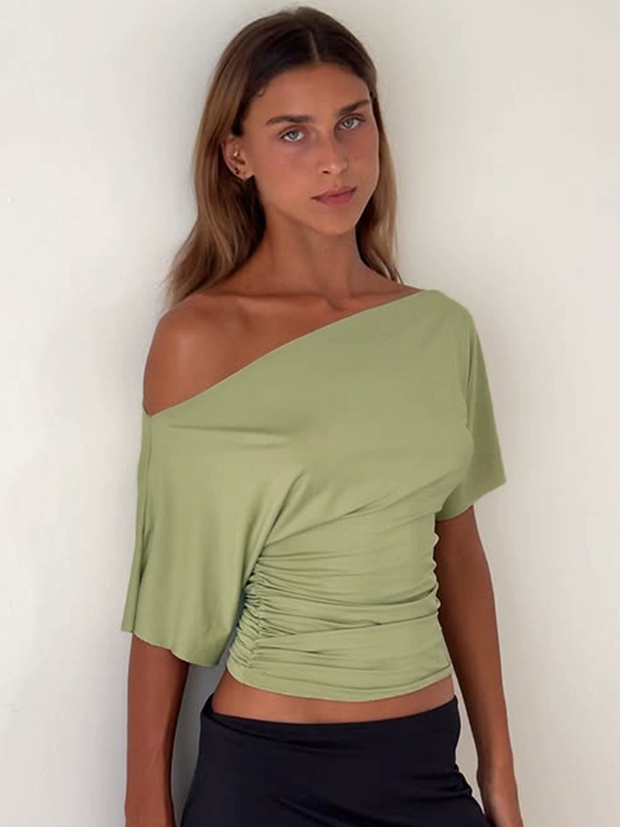 Shemoda: Noir Serene Top | Nüra - Discover Shemoda's Noir Serene Top: a sleek, stylish T-shirt with slanted shoulder and ruched waist for a modern, confident look. Perfect for any occasion. - $18.00