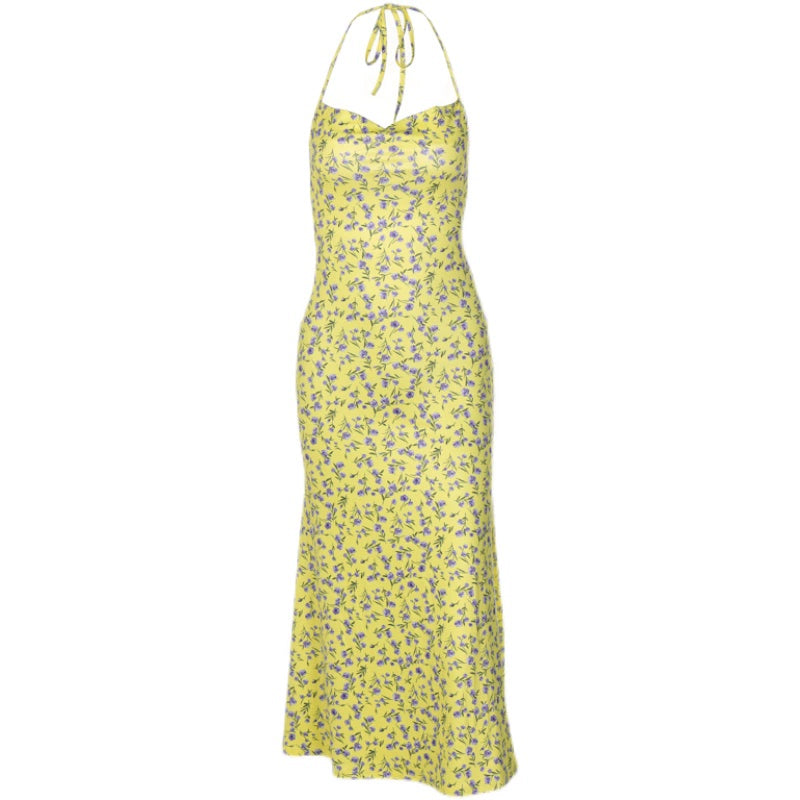 Shemoda: Flora Blossom Dress | Nüra - Discover Shemoda's Flora Blossom Dress: an elegant, sleeveless maxi with a tie-back neckline. Yellow with blue florals for a fresh, confident style. - $19.00