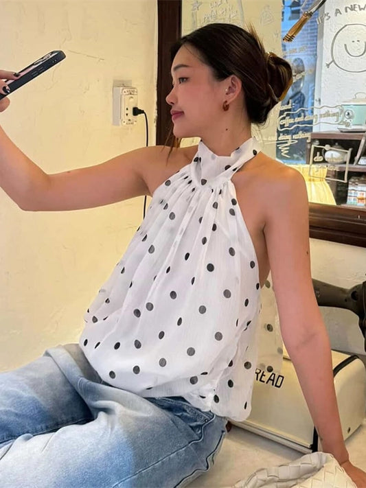 Shemoda: Zuri Halter Blouse | Nüra - Discover the Zuri Halter Blouse by Shemoda: a chic, backless chiffon top with playful polka dots and adjustable neck straps for versatile style. - $25.00